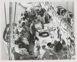 Image of Group on deck at Siorapudoo gathered around recorder